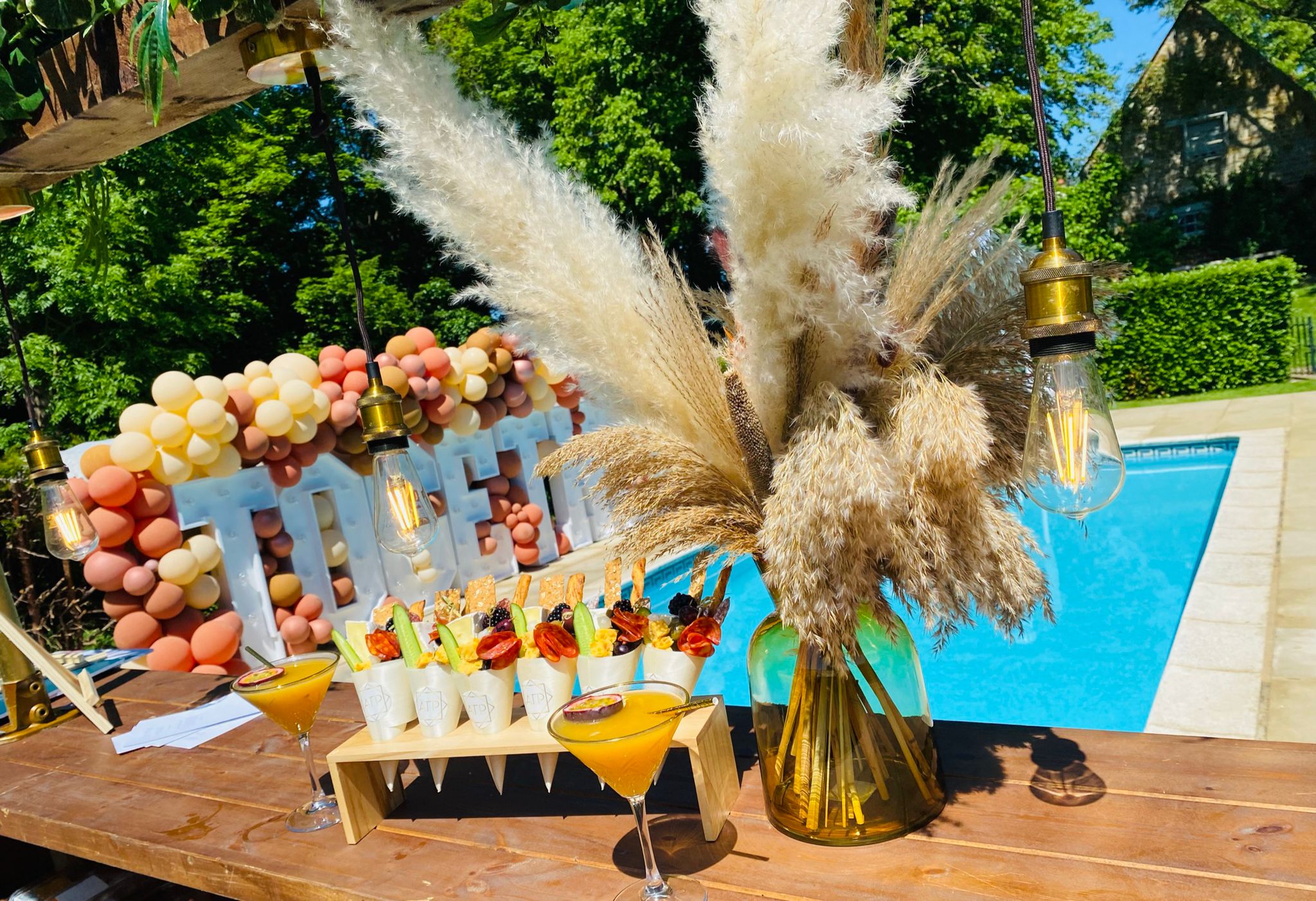 Celebration catering arranged beside a swimming pool