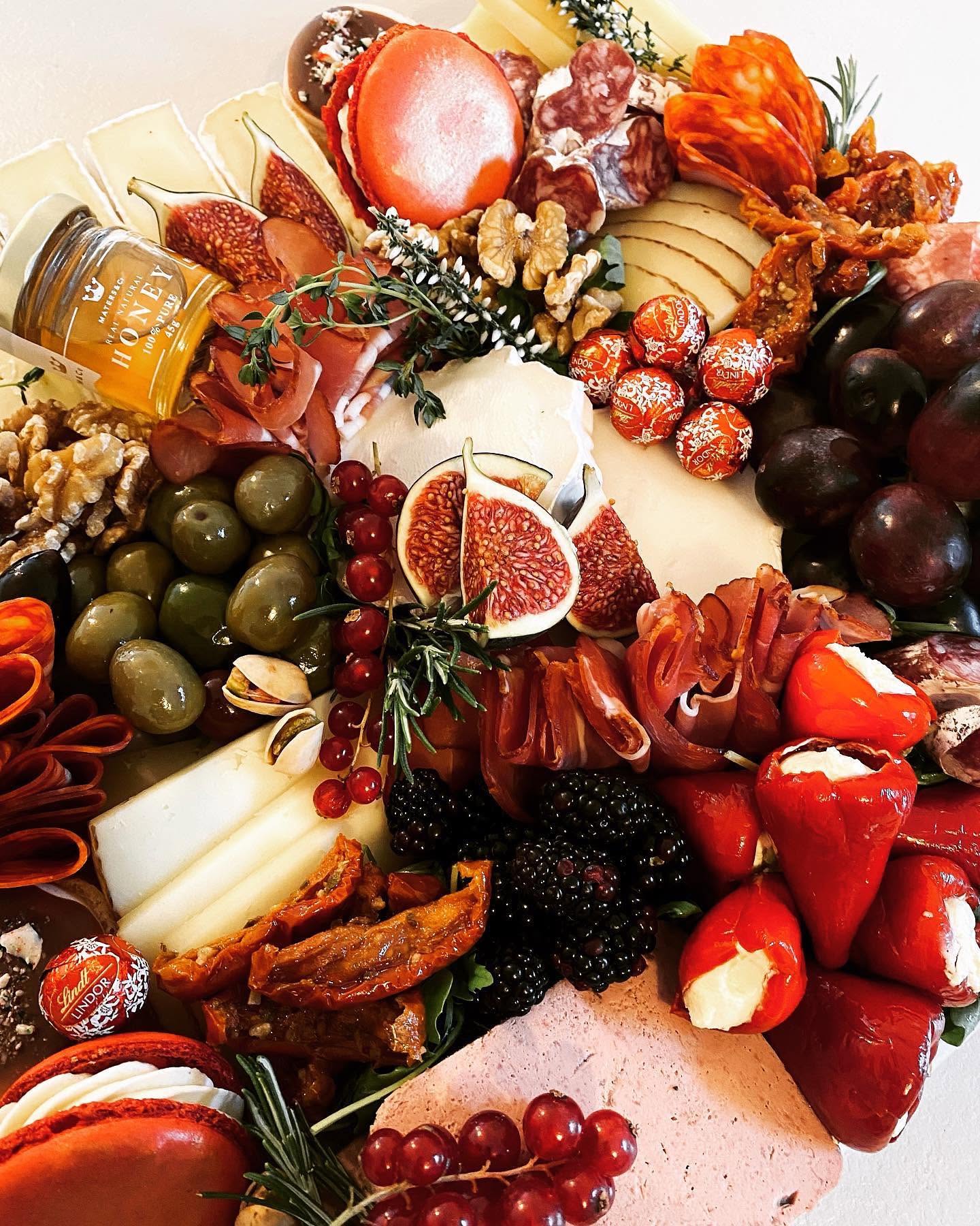 A festive catering spread with cheeses, charcuterie and seasonal details