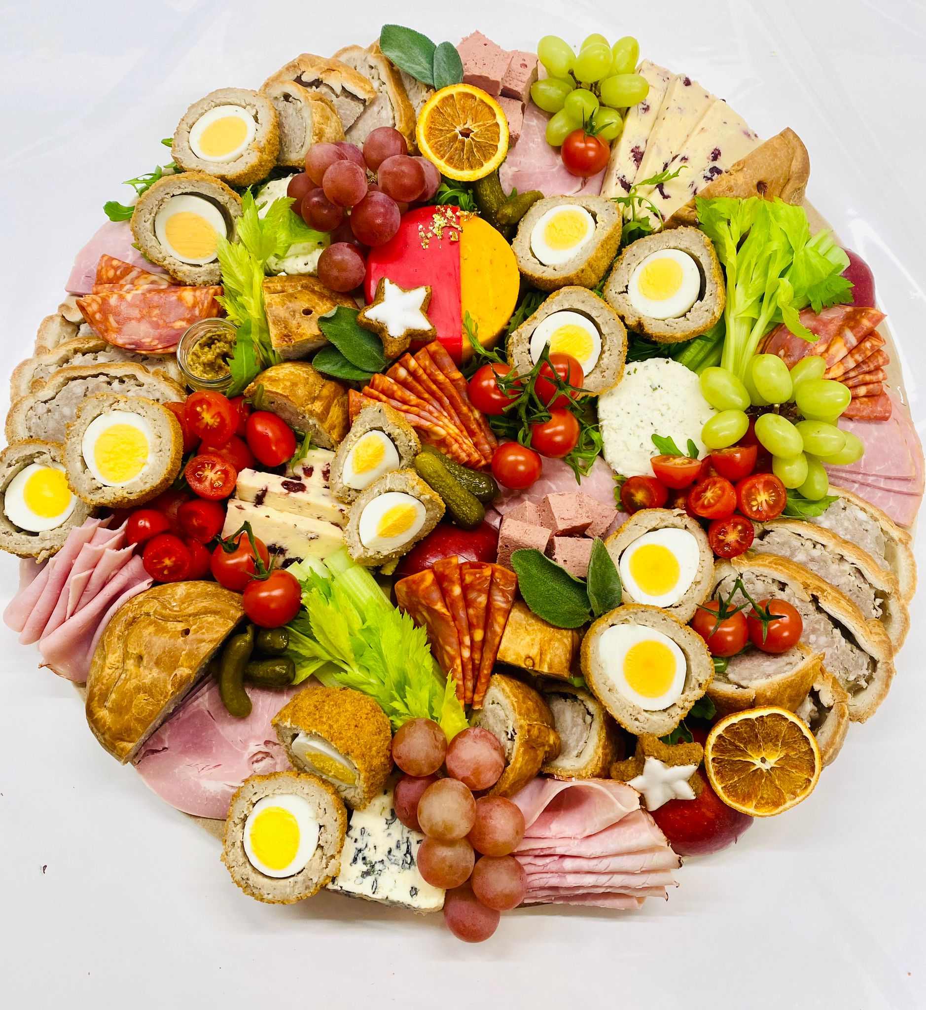 A generous Christmas platter with cheeses, meats, fruit and festive favourites